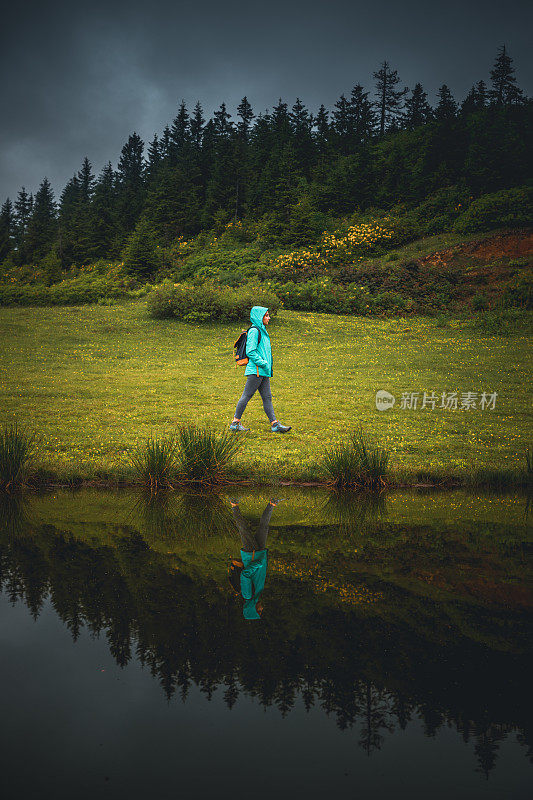 Young woman walking on coast near pond in Badara Plateau, Turkey